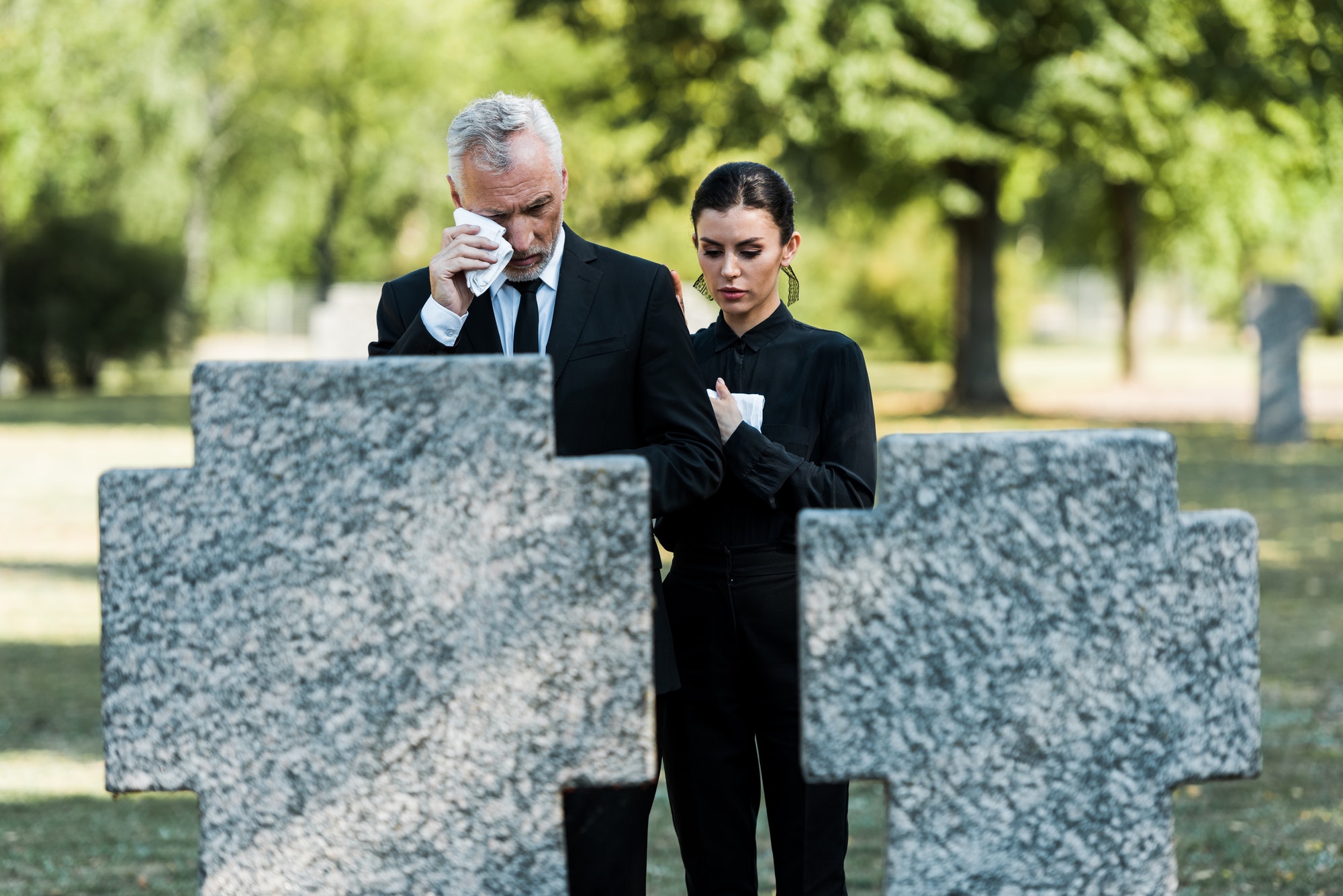 selective-focus-of-upset-man-crying-near-woman-on-funeral.jpg